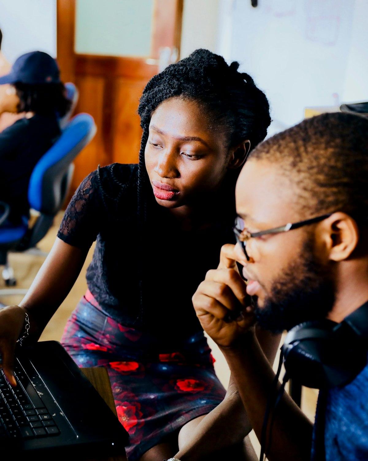 Two of the team reviewing work together at a desk